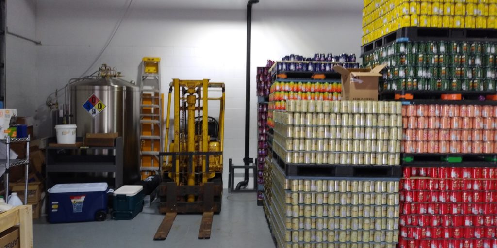 More of the production equipment and pallets of soda.